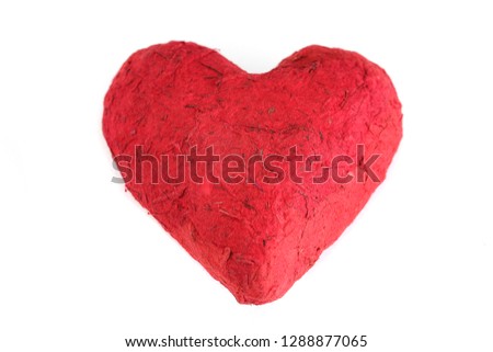 Handmade paper mache heart, closeup, isolated on white background. Love, romance, Valentine's Day concept.