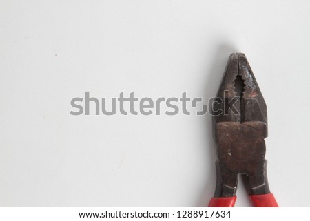 old red pliers in white background