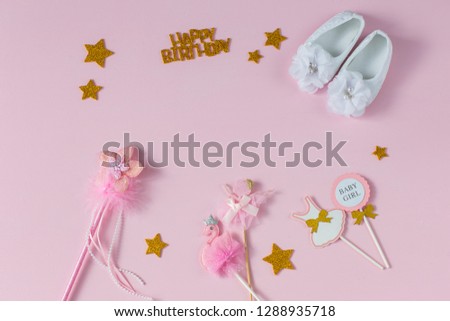 booties, magic wand, festive decor on a pink background (birthday card for the girl)