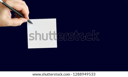 Top view of businessman writing on blank white notes. High angle view of man hand writing on empty notepad , . Closeup of male hand making notes. Isolated on black.