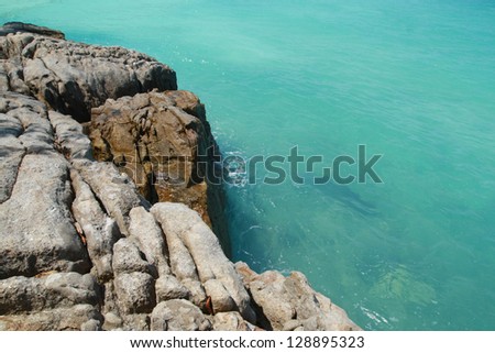 stone coast and blue sea , beautiful beach surface background ,travel landscape clean white sand beach and blue sea water wave ripple background, beautiful ocean and natural island