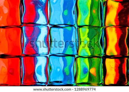 An abstract background of a colorful image distorted through a glass block wall