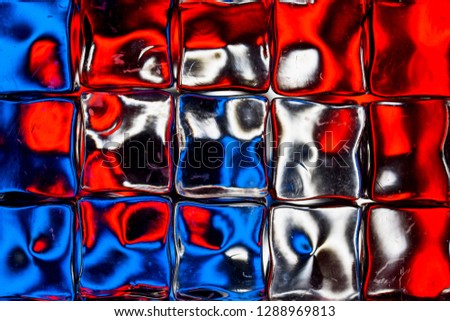 An abstract background of a colorful image distorted through a glass block wall
