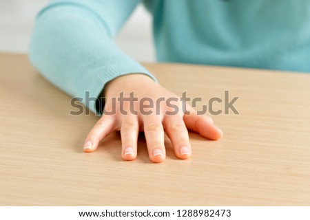 Closeup of a woman sitting and slapping on the table at bank Royalty-Free Stock Photo #1288982473
