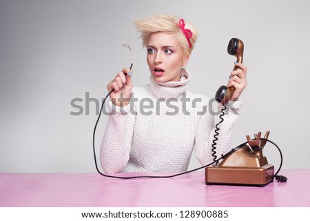 silly secretary finds out why phone not working Royalty-Free Stock Photo #128900885