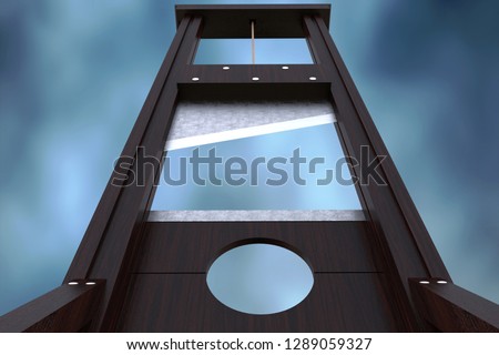 Guillotine instrument for inflicting capital punishment by decapitation and dramatic cloud background. Old wooden instrument for execution.  Royalty-Free Stock Photo #1289059327