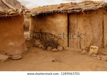 Mud huts in Masai Mara village, Kenya, Africa Royalty-Free Stock Photo #1289063701