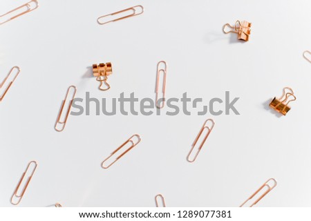 set of stationery paper clips copper color on white background
