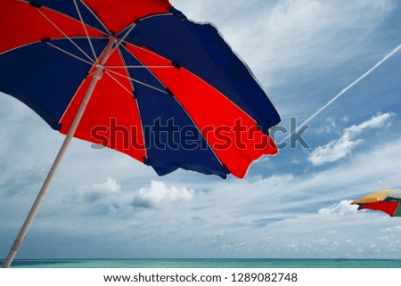 Umbrella from the sun against the beautiful blue sky. Protection from the sun, concept. Free space on the right