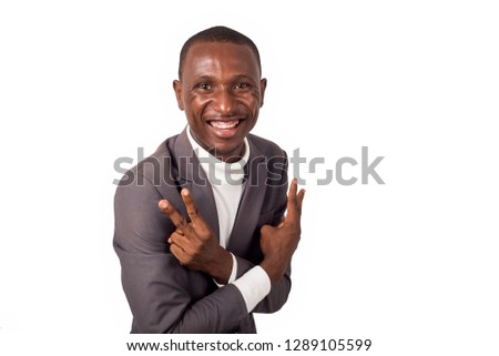 young happy man in suit making victory sign of fingers