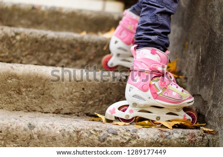 girl's legs in pink roller skates