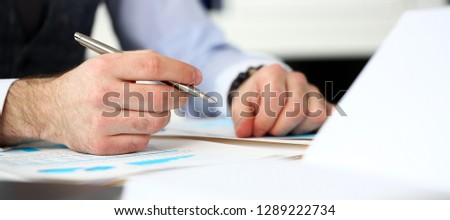 Clerk man at office workplace with silver pen in arms do paperwork closeup. Staff dress code worker job offer client visit study profession boss market idea coach training