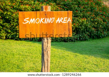 Wooden smoking area sign in the garden
