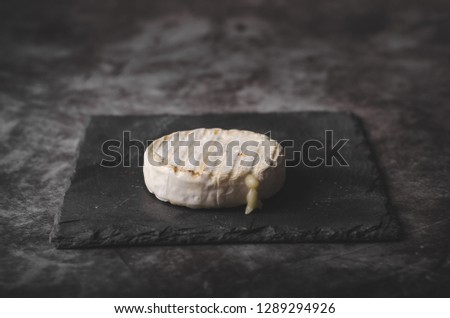 Fresh organic cheese, simple on black background