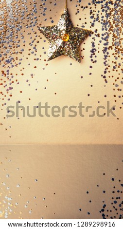 Gold background, sparkling background with  golden star, sparkles, christmas tree decorations with mirror reflection