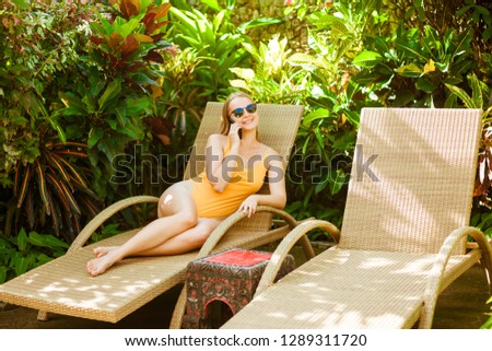 girl talking on the phone on the sunbed