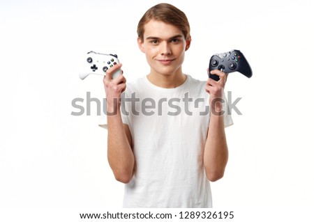 The guy with the two controllers in his hands playing the console White t-shirts of the game