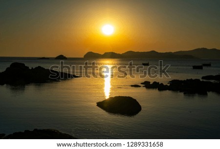 The sun rising through the reefs