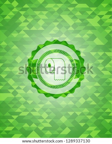 toilet paper icon inside green emblem with triangle mosaic background