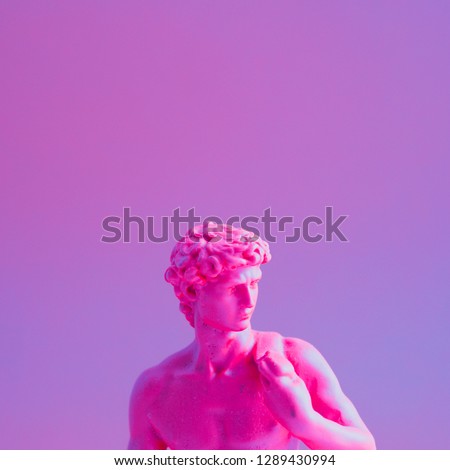 Creative concept of purple neon David is a masterpiece of Renaissance sculpture created  by Michelangelo. Vaporwave style  
 Royalty-Free Stock Photo #1289430994