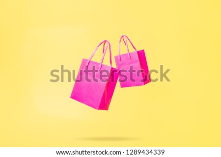 Flying Shop Bags Store Sale Concept Pink and Yellow Color