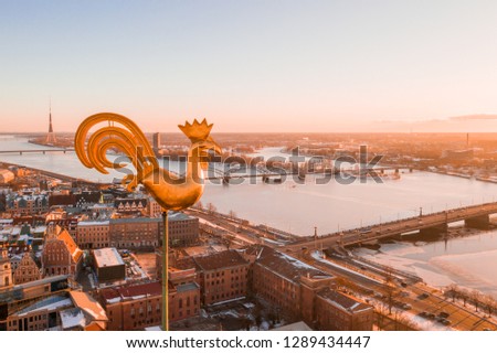 Golden cock on the top of the Dome Cathedral during sunset. Beautiful Riga wallpaper