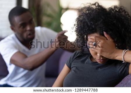 Tired frustrated african wife ignoring angry black despot husband arguing blaming upset woman of problems, jealous man shouting at sad girlfriend, family fight and controlling boyfriend, disrespect Royalty-Free Stock Photo #1289447788