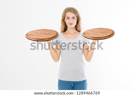 Wooden pan. Young woman in summer blank tshirt holding empty pizza tray isolated on white background. Copy space and mock up. Template t shirt background.