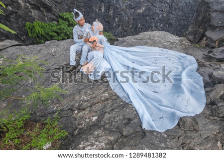 Outdoor shooting for Malay wedding, the bride and groom wearing Malay traditional cloth with  old mine as background .