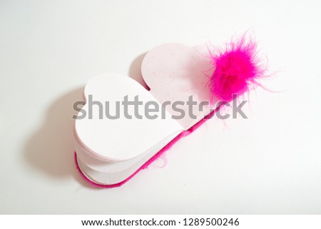 
Pink heart shaped Notepad on white background