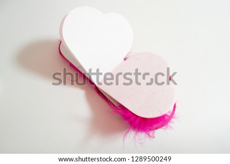 
Pink heart shaped Notepad on white background