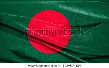 Realistic flag of Bangladesh on the wavy surface of fabric. Perfect for background or texture purposes