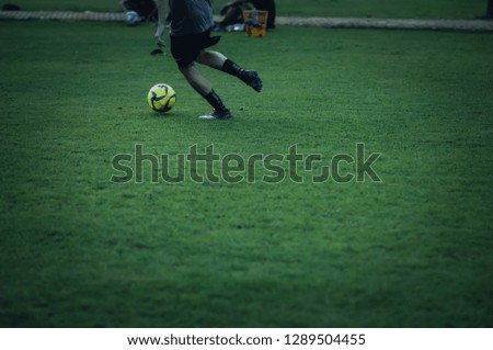 Football practice and spot focus at ball