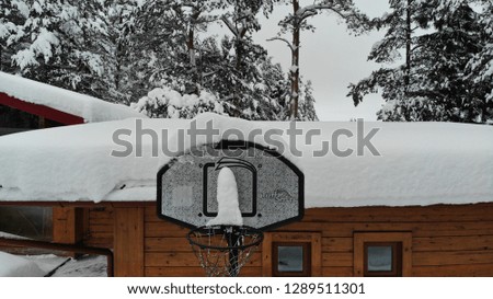 basketball hoop on a snow covered roof