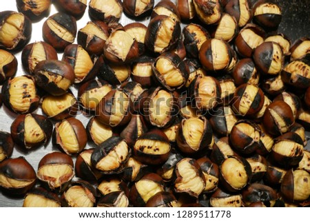 Roasted chestnuts on a metal plate