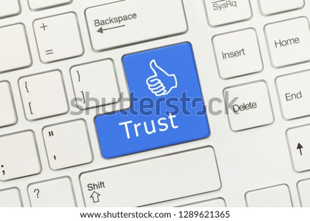 Close-up view on white conceptual keyboard - Trust (blue key)