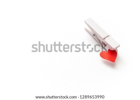 White clothespin with a small red heart Isolated on a white background