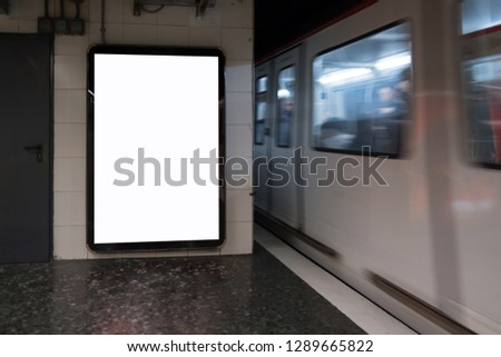 Light box screen with white blank space for advertisement and train running nearby in tube. Marketing mock-up concept. 