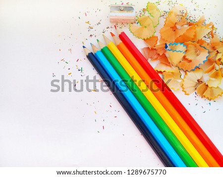 Stationery set for drawing on white background include crayons, ruler, eraser, sharpener and debris from the sharpening - Image