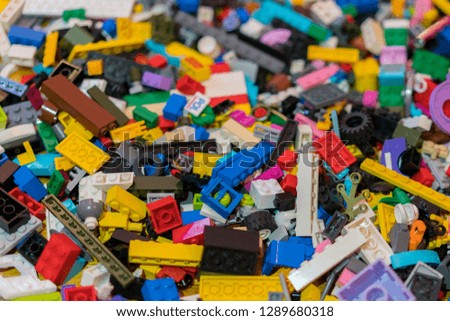 Close up of colorful plastic bricks on the floor. Early learning. Children's plastic constructor on the floor. background.