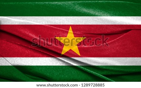 Realistic flag of Suriname on the wavy surface of fabric. Perfect for background or texture purposes