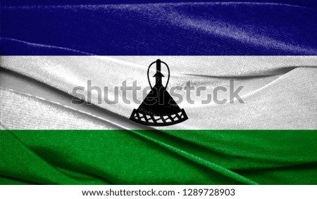 Realistic flag of Lesotho on the wavy surface of fabric. Perfect for background or texture purposes