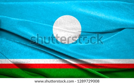 Realistic flag of Sakha Republic on the wavy surface of fabric. Perfect for background or texture purposes