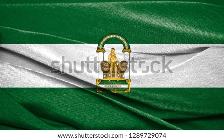 Realistic flag of Andalusia on the wavy surface of fabric. Perfect for background or texture purposes