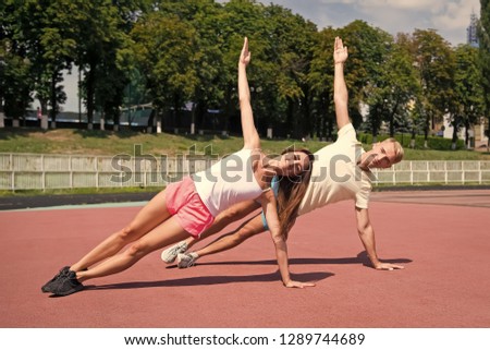 Sport and fitness. Couple workout and stretching. Summer activity and energy. Man and woman sunny outdoor on blue sky. Coach and health.