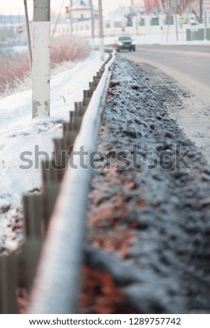 Winter highway with metal safety barrier