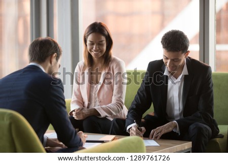 Arabic and caucasian business partners parties signing two contracts at multi-ethnic meeting, diverse businessmen in suits making investment agreement deal fill document put signature on legal papers Royalty-Free Stock Photo #1289761726