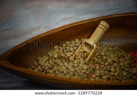 Organic green leentils in a wooden bowl