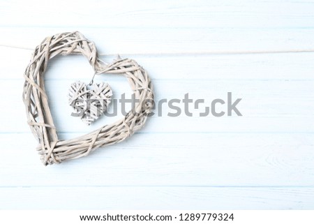 Grey heart hanging on wooden background