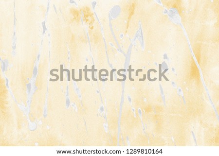 Luxury gold and white metal paint splatter effect on watercolor paper background. Gold glitter splash texture. Beautiful feminine backdrop.